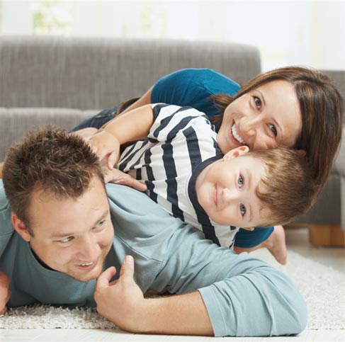 A happy family inside on carpet